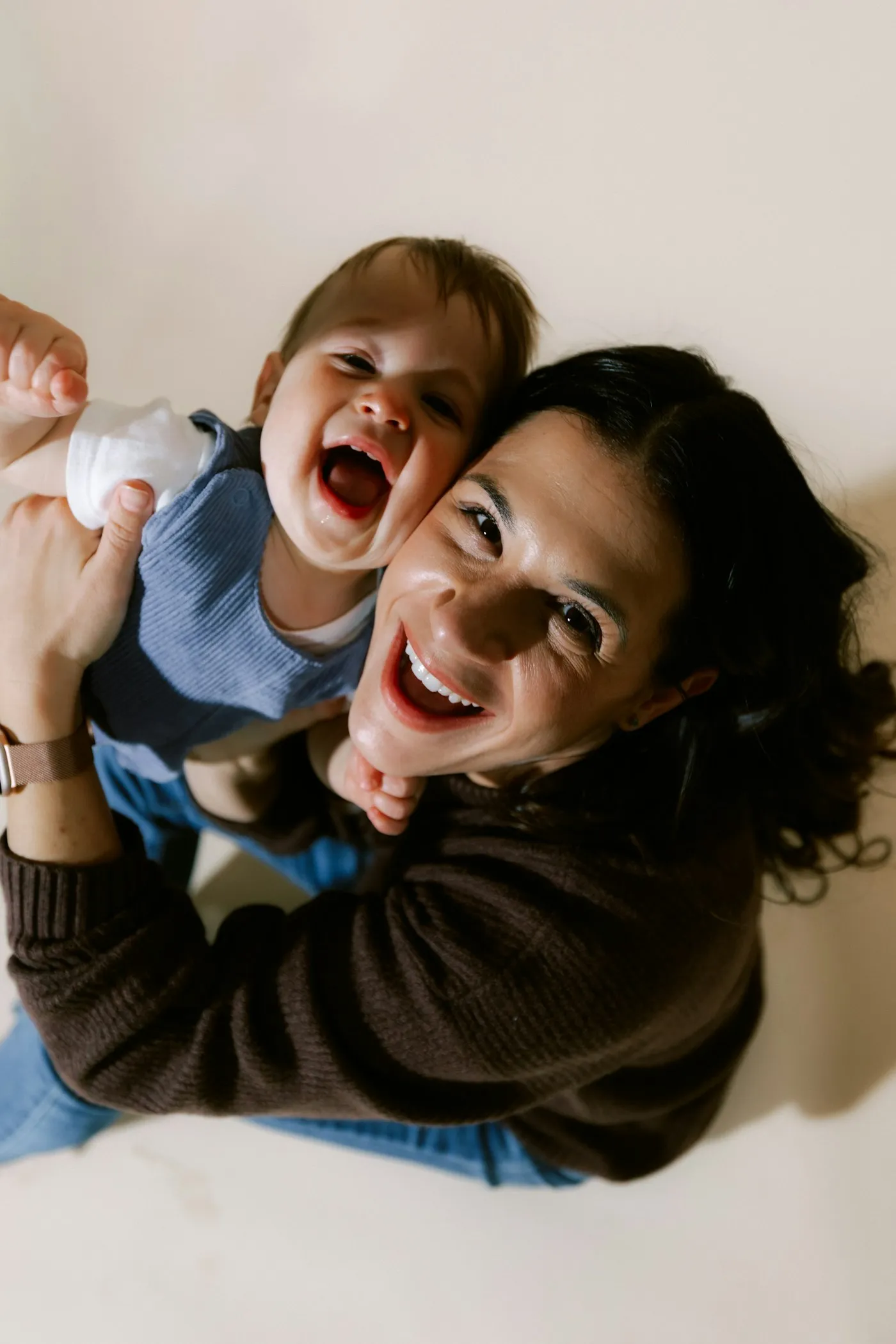 A mother and her baby laughing together