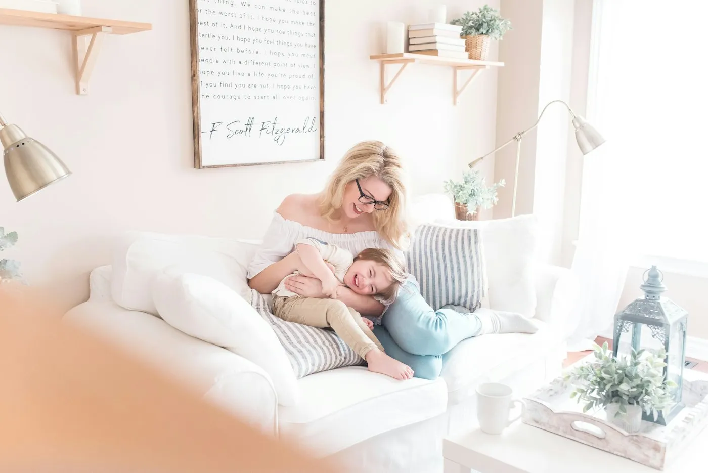 A mother resting on the sofa with her baby